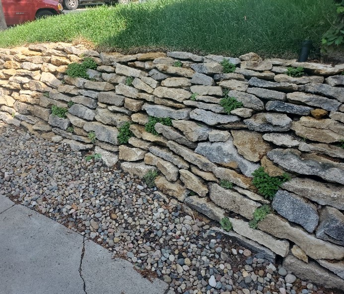 A retaining wall constructed of flat stones.